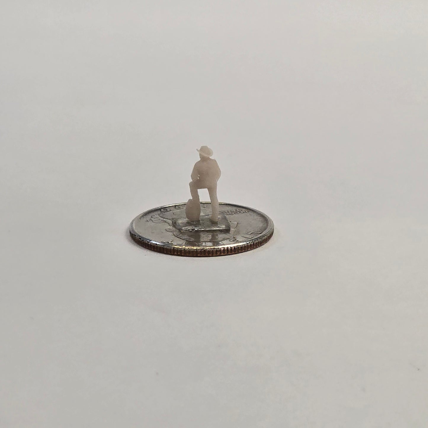 N Scale Cowboy – Foot on Barrel | Unpainted Western Miniature for Dioramas & Train Scenes
