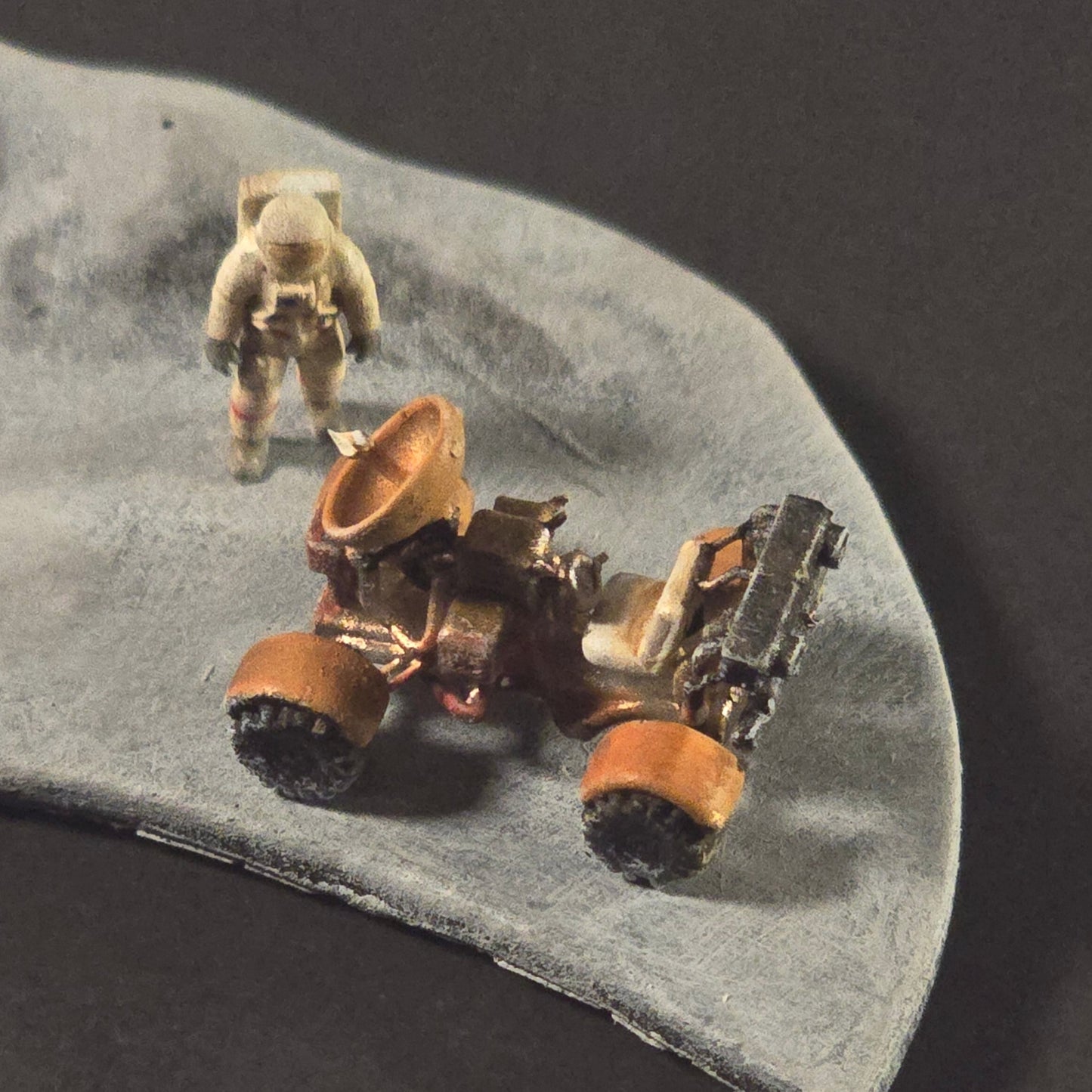 “Complete Apollo lunar mission diorama featuring painted and weathered lunar lander, rover, astronauts, tools, and flag displayed on a sculpted lunar base.”