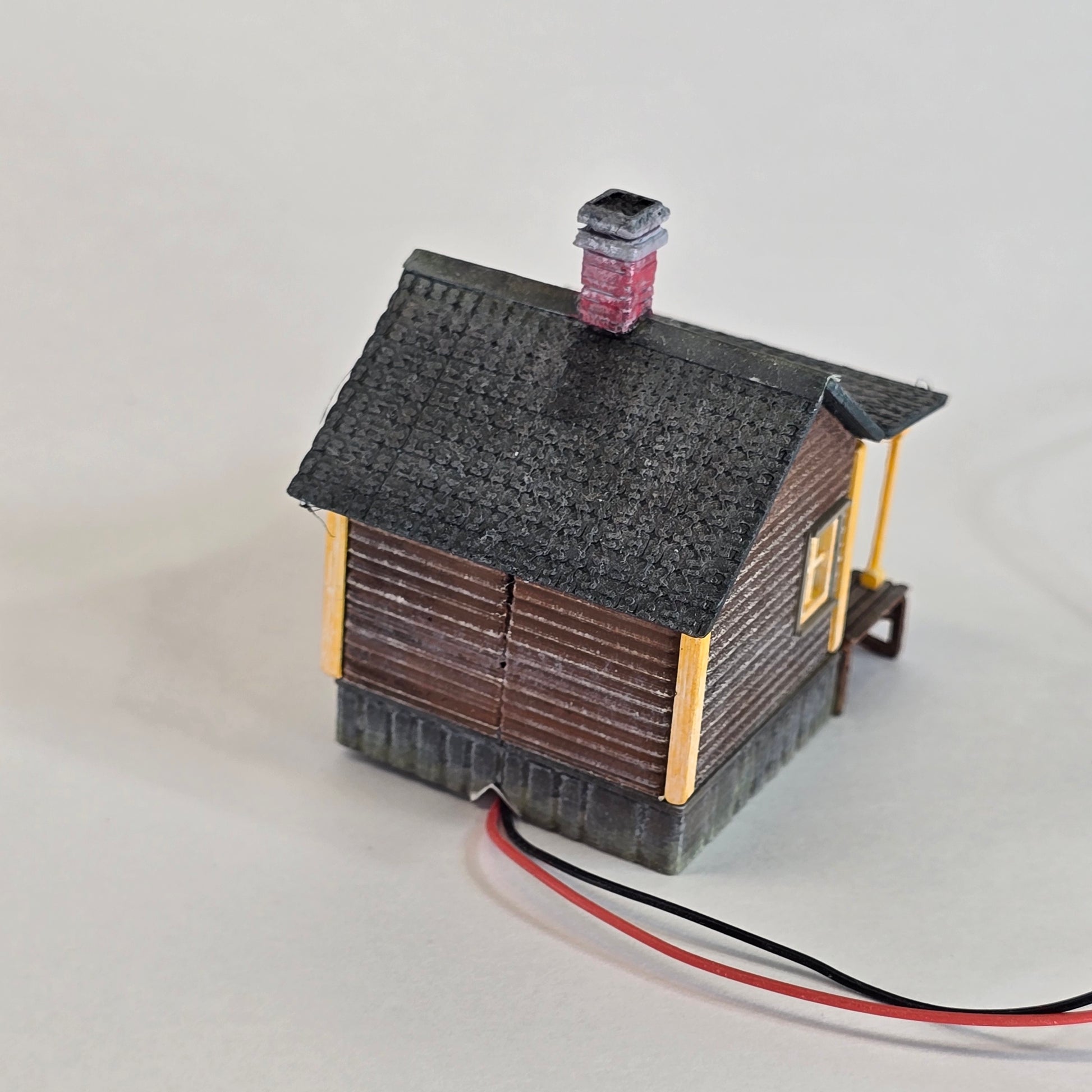 Small electronic device with wires on a light gray background
